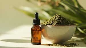Kratom Active 28 Kratom extract tincture beside whole leaf powder